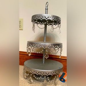 Opulent treasures, three tier silver metal stand, draped beads, glass teardrops.
